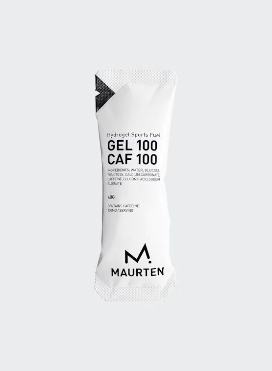A white packet labeled Maurten Hydrogel Sports Fuel Gel 100 CAF 100, featuring hydrogel technology, with ingredients and caffeine content listed in black text on the front. Rectangular sachet with crimped edges and a tear notch at the top. Matte finish packaging. Sans-serif black typography is used for all visible label text. Plain white background, no people or objects present. Shot is a straightforward product close-up showing only the front of the packet.