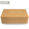 A rectangular cork yoga block is shown against a white background. The block is light brown with a matte surface and visible cork texture. There is no packaging. In the top left corner, text in thin, all-caps font reads 100% eco-friendly, made from sustainable cork. No people or hands are present in the image. Shot is direct and product-focused.