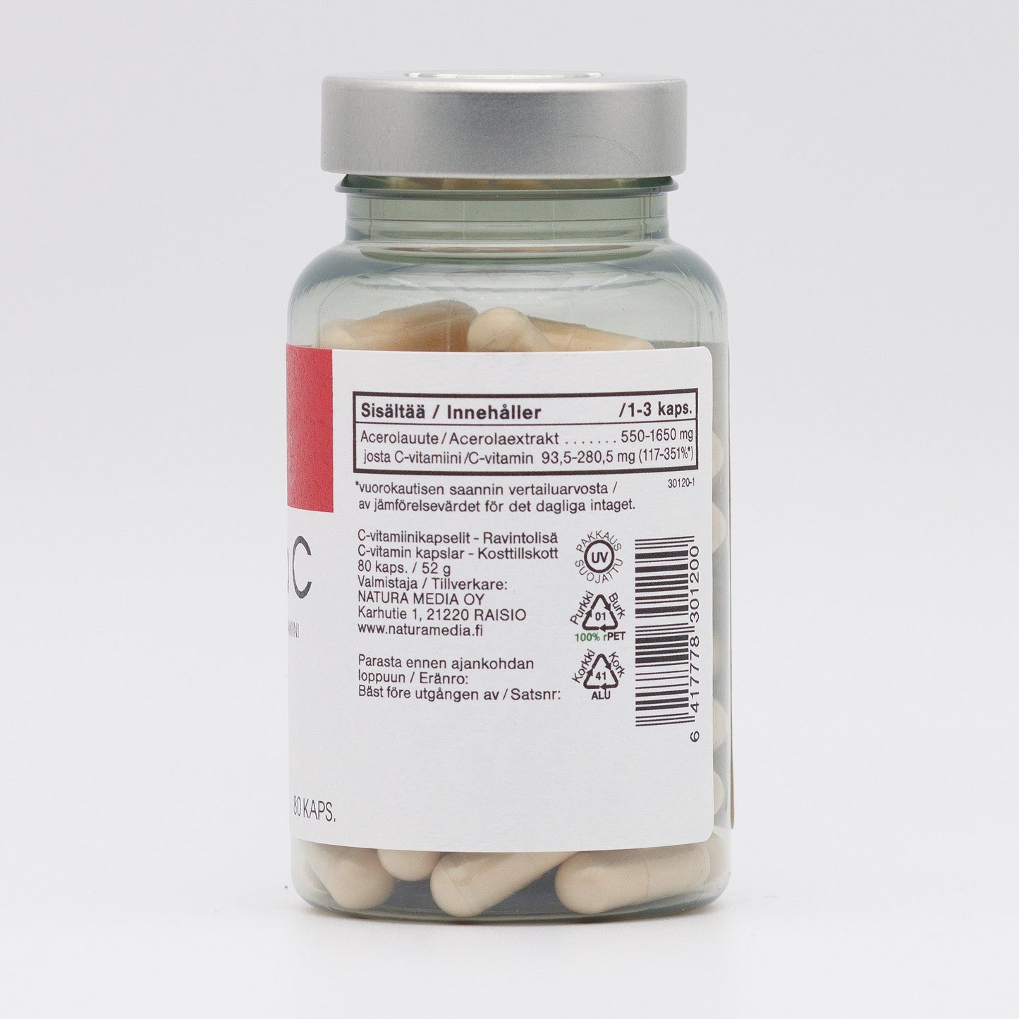 A clear plastic bottle with a cylindrical shape contains white capsules. The back label is multilingual and displays text, nutritional facts, ingredients list, and a barcode in black print. The bottle has a matte white screw cap. No people or hands are visible. Plain light background. A clear bottle containing white capsules features a multilingual label with nutritional information, ingredients, and a barcode on the back.