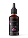 A brown glass dropper bottle labeled Nordicure Pau DArco (Tabebuia impetiginosa) with pink tree graphics and bilingual text in Finnish graces a sleek black label. The cylindrical bottle is topped with a black dropper cap. Label text uses sans-serif fonts arranged horizontally. The surface of the glass is reflective, and the setting is a plain white background with no additional objects or people present.