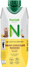 A NutriLettt Creamy Chocolate Banana flavoured shake carton with a green cap, 330 ml, labeled as very low calorie, added fiber, and meal replacement, featuring an image of a glass of the shake and banana slices. The carton has a rectangular shape with glossy finish and features bold lettering on the front. The product is photographed against a plain white background with no people or additional objects visible.