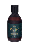 A dark brown bottle with a black flip-top cap labeled Ole Hyvä Metsä Naava Shampoo & Suihkugeeli, featuring a dark green label with gold and white text. The bottle is cylindrical and made of plastic with a matte finish. Typeface on the label is sans-serif in both block and script styles. The image is taken against a plain background, showing only the product standing upright.