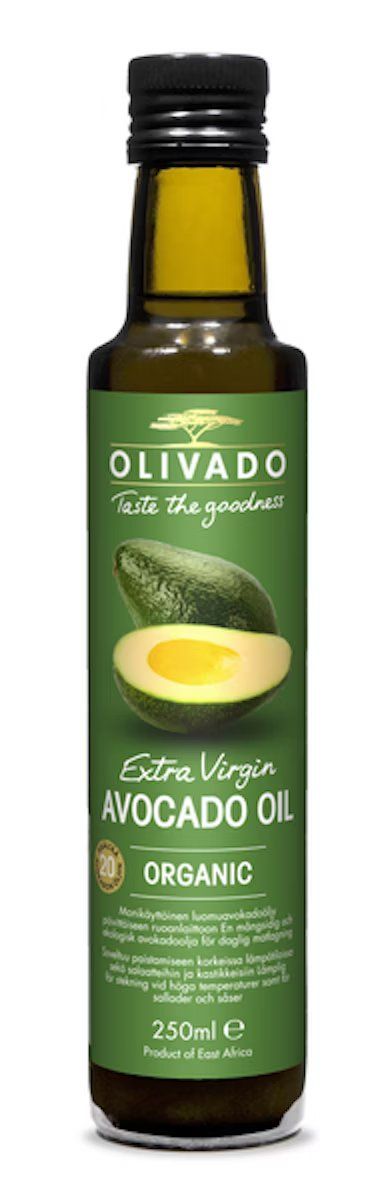 A green glass bottle of Olivado Extra Virgin Avocado Oil with a matte finish, cylindrical shape, and a screw cap. The front label has white sans-serif text and includes the words “organic,” “extra virgin,” and “cold-pressed avocado oil,” along with an image of a halved avocado. The volume is 250 ml. The product origin stated is East Africa. Background is plain and uncluttered.