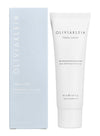 A tube and box of Oliviaklein Hydra Lotion, an intensely hydrating moisturizer, with minimalist white and light blue packaging, displayed side by side. Both items have a matte finish; the tube is cylindrical with a white cap, and the box is rectangular. The label features simple sans-serif text in black. The background is plain and uncluttered. No people or hands are present in the image.