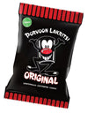 A black bag of Porvoon Lakritsi Original licorice features a cartoon licorice character on the front, red accents around the product name, and a green vegan label located in the top left corner. The packaging is glossy plastic with bold white and red typography. No people or hands are visible. The image has a plain background and is shot as a single product close-up.