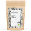 A brown resealable pouch labeled puhdas+ Ruomu Chia-Siemenet, featuring a patterned design with abstract leaves and dots. Matte finish; flexible rectangular packaging. Label text includes references to organic chia seeds, omega-3, protein, and eco-certification. Sans-serif type in contrasting white over brown background. No people or hands visible. Neutral backdrop; studio product shot.
