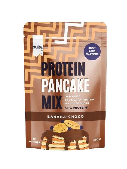 A pouch of Puls Protein Pancake Mix in banana-choco flavor, featuring pancakes drizzled with chocolate syrup. Packaging is matte, mostly brown and yellow with an oat graphic and image of pancakes. Product details—36g protein, no added sugar, 500g, 10 servings—are printed in bold sans-serif font on the front. No people or hands are visible. Neutral background, studio lighting.