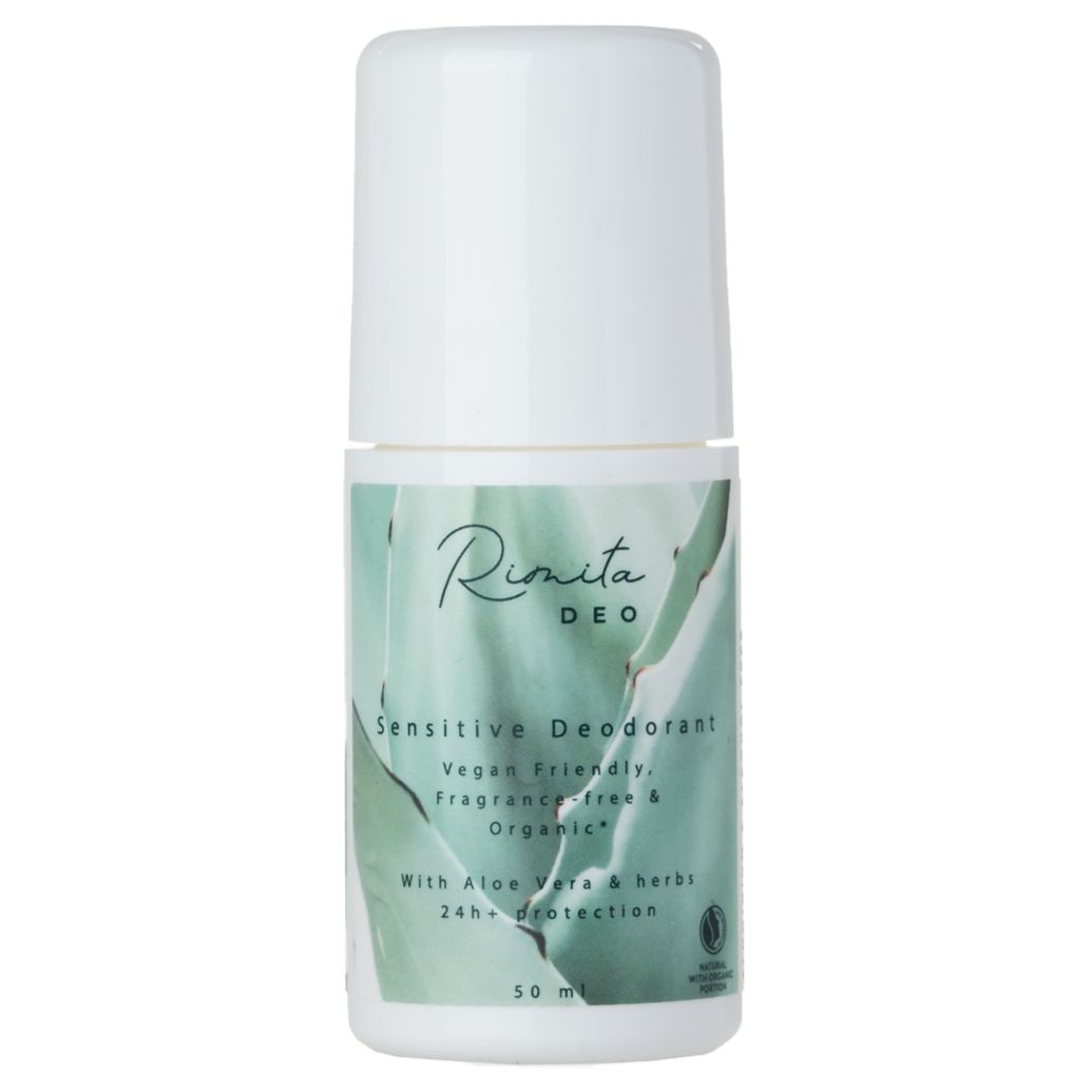A white roll-on deodorant bottle labeled Rinita DEO Sensitive Deodorant, vegan friendly, organic, and fragrance free, with aloe vera and herbs, 50 ml, shown against a plain background. The bottle has a smooth cylindrical shape with a rounded cap and matte finish. Label uses clear sans-serif font in black text on white. No people or hands visible. Centered product shot with even lighting.