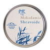 A round tin labeled Makadamia Sheavoide with blue illustrations of grass and a macadamia nut. The text SAAREN TAIKA appears below a wave and sun icon. Matte-finish, smooth metal container with an off-white label, simple sans-serif typography. Product is photographed front-facing on a plain, neutral background with no people or hands visible.