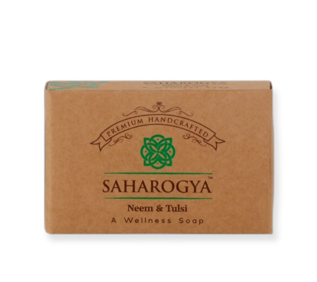 A rectangular, matte-finished brown box of Saharogya premium handcrafted wellness soap, labeled Neem & Tulsi. The packaging displays green ornamental and ayurvedic motif graphics with legible product text in a clean sans serif typeface. The box is photographed against a plain light background, with no people or hands visible.