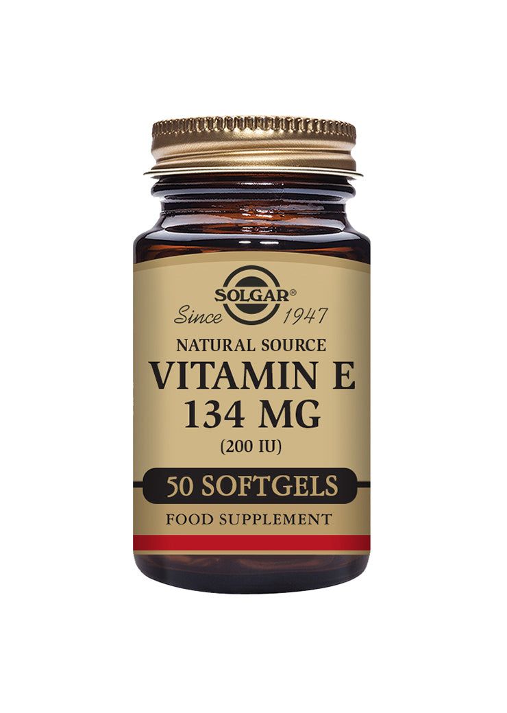 A brown, cylindrical glass bottle with a shiny gold screw cap is shown on a solid white background. The front label displays product details in bold serif and sans-serif fonts with dark text on a beige background and metallic gold accents. No people or actions are present. A brown bottle labeled Solgar Vitamin E 134 mg (200 IU), 50 softgels, natural source, antioxidant food supplement with a gold cap on a white background.
