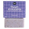 A purple bar of soap with a matte finish sits below a matching rectangular box. The box is labeled “Keijujen Aito Palasaippua” in Finnish and displays a black “Sopo” logo in bold, rounded letters at the top. The box features a dense, decorative pattern in complementary colors. No people or hands are present; the shot has a neutral background.