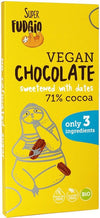 A yellow Super Fudgio vegan chocolate bar featuring a playful illustration of a sloth eating dates. The wrapper is matte and rectangular, with bold sans-serif typography for the product name and claims. Icons indicate gluten-free, palm oil–free, and organic. Key label text: 71% cocoa, sweetened exclusively with dates, crafted from only 3 ingredients. No people or background visible in the shot.