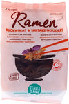 A package of TerraSana Ramen Buckwheat & Shiitake Noodles, featuring a black bowl with chopsticks holding noodles. The front shows matte finish packaging with a photo of the dish. Text includes “gluten-free,” “organic,” and “4 ramen cakes made with buckwheat.” Sans-serif font is used. No people or hands visible. White background, product-centered shot.