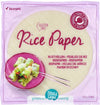 Package of TerraSana rice paper with spring rolls pictured on a pink plate. Round, clear plastic packaging with blue and white labels; matte finish. Sans-serif bold typography is used for main product name and highlighted information. The package and plate rest on a solid surface in a well-lit studio setting. Text highlights gluten-free, organic, and plant-based product info in multiple languages.