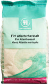 A bag of Urtekram Fine Atlantic Sea Salt with multilingual labeling and a blue-green wave design on the front. The 1 kg package is rectangular with a matte finish. Branding and product information are printed in clear, sans-serif text. The background is plain and uncluttered with no people or hands visible. Wide product shot includes full packaging front view.