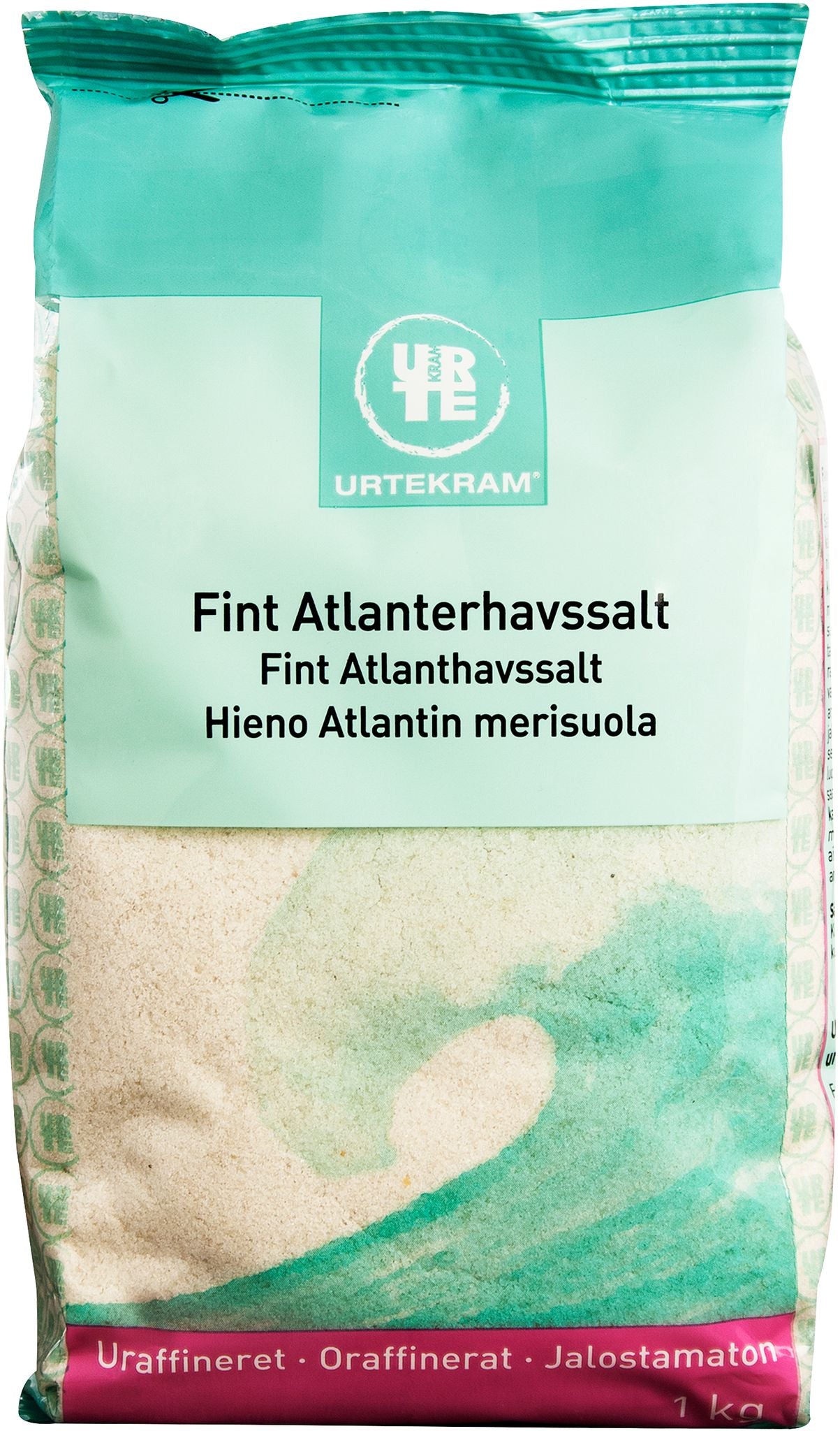 A bag of Urtekram Fine Atlantic Sea Salt with multilingual labeling and a blue-green wave design on the front. The 1 kg package is rectangular with a matte finish. Branding and product information are printed in clear, sans-serif text. The background is plain and uncluttered with no people or hands visible. Wide product shot includes full packaging front view.