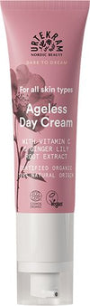 A tube of Urtekram Ageless Day Cream with Vitamin C and ginger lily root extract, labeled for all skin types, organic, vegan, with 99% natural origin ingredients. The pink and white package features floral graphics. Tube is upright with a matte finish; label text uses simple sans serif fonts in white and pink. Product is photographed against a plain light background; no people or hands are visible.