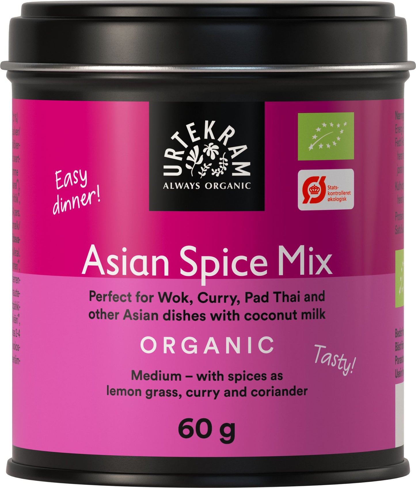A cylindrical tin with a matte purple and black label is shown. The label includes the text: “A tin labeled Urtekram Asian Spice Mix, 60g, for wok, curry, pad Thai, and other Asian dishes. This organic blend features medium spice with lemongrass, curry, coriander, and a hint of exotic flavor. The label is purple and black.” Sans-serif fonts are used on the packaging. The background is plain white. No people or hands are present in the image.