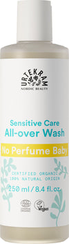 A bottle of Urtekram Nordic Beauty Sensitive Care All-over Wash labeled No Perfume Baby, 250 ml, certified organic and vegan, made with 100% natural origin ingredients. The cylindrical plastic bottle is white with a matte finish, displaying blue and yellow text and plant illustrations. The packaging includes a pump dispenser. Text is in sans-serif font. Plain white background with no people or hands visible.