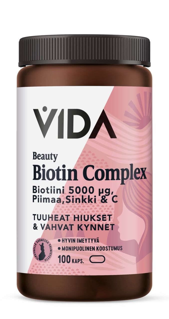 A brown plastic bottle labeled VIDA Beauty Biotin Complex with 5000 µg of biotin, calcium, zinc, and vitamin C. This supplement supports thick hair and strong nails. The bottle contains 100 capsules, and the label is mostly white and pink. Matte finish on bottle surface; cylindrical shape with a screw cap; sans-serif font dominates the label; shot shows only the product against a plain white background with no people or additional objects visible.