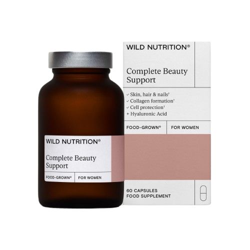 A brown glass bottle labeled Complete Beauty Support sits next to its box packaging, which highlights benefits for skin, hair, nails, collagen production, cell protection, and hyaluronic acid. This dietary supplement contains 60 capsules. The bottle has a smooth, semi-gloss finish and a white screw cap. Typography is clear and modern. Both items are placed upright on a plain white background in a studio shot.