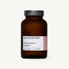 Wild Nutrition Food-Grown Premenstrual Support for Women -pullo, ruskea lasipullo mustalla muovisella kierrekannella, mattapinnalla; etiketti valkoinen mustin tekstausvapain tekstein, brändinimi lihavoituna; sylinterimäinen pullo keskitettynä vaaleaa taustaa vasten; ei ihmisiä, käsiä tai rekvisiittaa näkyvissä.