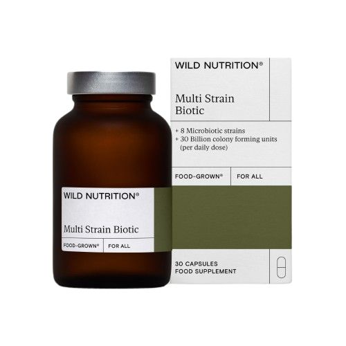 A brown glass bottle and matching rectangular box with matte finish, both labeled Wild Nutrition Multi Strain Biotic, containing 30 capsules of a food supplement with live cultures, featuring 8 microbiotic strains and 30 billion CFU per daily dose. Bold sans-serif typography in black on a white background; no people or hands visible; product set against a plain surface.