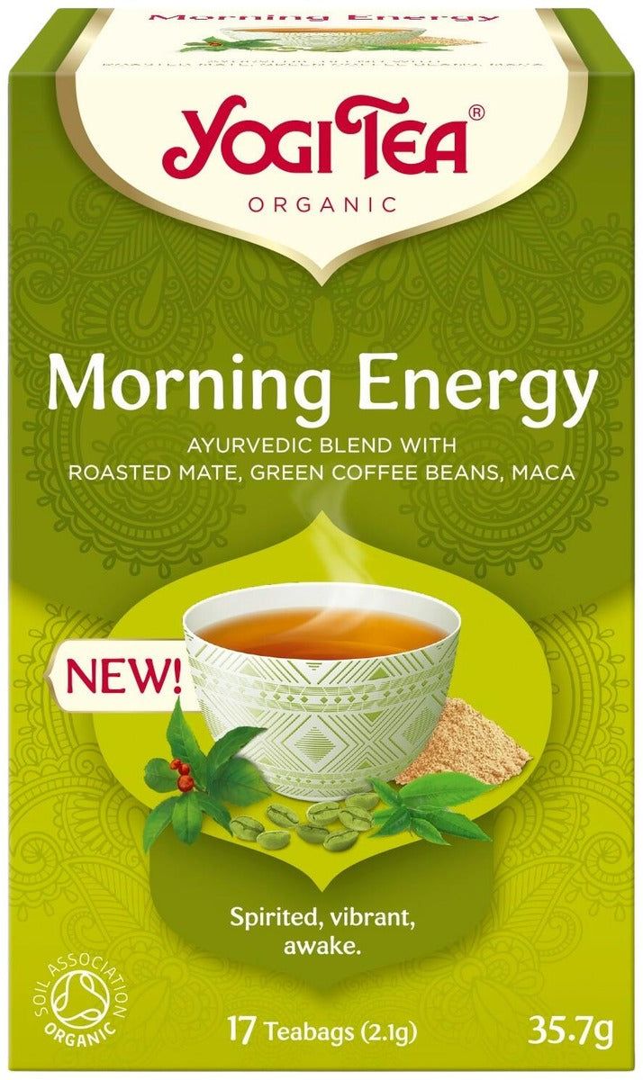 Box of Yogi Tea Morning Energy featuring a cup of tea, green and tan accents, and text highlighting invigorating ingredients: roasted mate, green coffee beans, and maca. Matte-finish rectangular cardboard box with bold sans-serif typography on the front. Label says spirited, vibrant, awake with 17 organic teabags and an organic seal. Product set against a plain light background with no people visible.