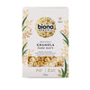 A box of Biona Organic Pure Oaty Granola, 375g, featuring gold leaf designs, a vegan logo, and a window displaying the granola. The package is rectangular with a matte surface and dark background. Serif and sans-serif fonts are used for the visible label text: high in fibre, sweetened with rice syrup, free from palm oil. The setting is neutral; no people or hands visible.