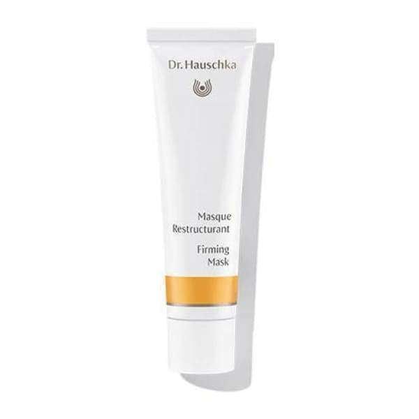 A white tube labeled Dr. Hauschka Masque Restructurant Firming Mask, featuring a gold band near the bottom, is shown upright against a plain background. The tube has a smooth, matte surface and cylindrical shape with a flat white cap. Typography on the label is sans-serif in black and gold. No people or other objects are visible in the image.