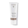 A white tube of Dr. Hauschka Regenerating Day Cream stands upright, featuring brown and silver accents with the product name printed on the front. The tube is made of plastic with a matte finish and features a silver screw cap. The label uses sans-serif lettering in black and brown tones. The background is plain white with even lighting, showing no people or additional objects in the frame.