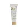 A white tube of Repairing Hand Cream with a matte finish and a cylindrical wooden cap, shown upright. The front label displays illustrations of green leaves and text mentioning chamomile extract, sweet almond oil, orange oil, and vitamin E in sans-serif typography. Plain background; no people or props visible.