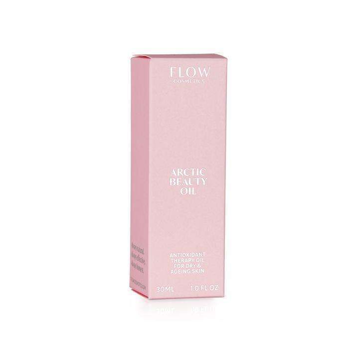 A pink rectangular box labeled FLOW Cosmetics Arctic Beauty Oil, featuring antioxidant therapy for dry, aging skin, 30ml, 1.0 fl oz stands against a white background. Box appears to be made of matte cardboard with clean edges and a simple modern sans-serif font. All visible surfaces are pink aside from the printed text. No people or props are present in the image.