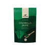 A green, rectangular, matte-finish package labeled FOODIN Korean Chlorella Jauhe is shown. The front displays an image of seaweed and a wooden spoon filled with powder. Bold white and yellow text indicates organic Korean chlorella powder, 300g. No people or hands are visible; the product is photographed against a plain background.