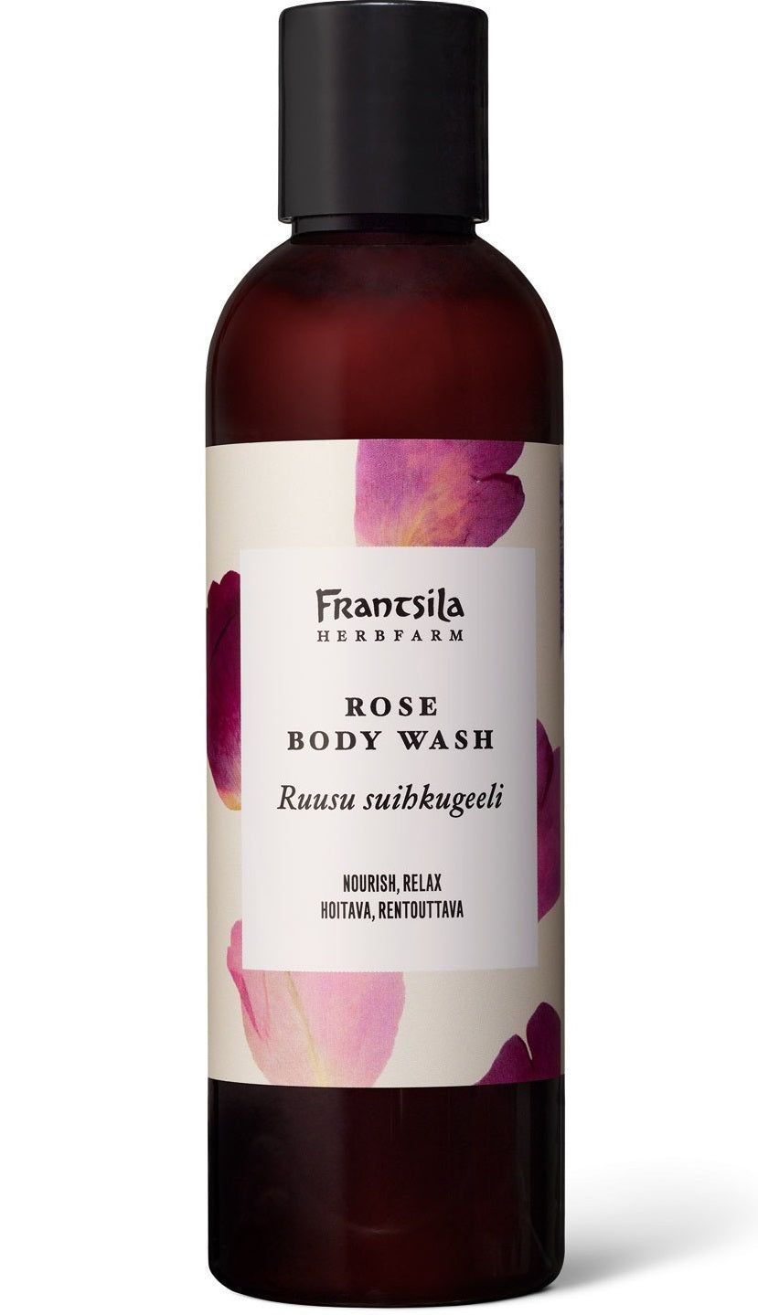 Frantsila Herb Farm Rose Body Wash (Ruusu Suihkugeeli) -pumppupullo, ruskea, valkoinen suorakaiteen muotoinen etiketti musta-pinkillä tekstillä; vaaleanpunaisia ruusunterälehtiä pullon vieressä, teksti englanniksi ja suomeksi
