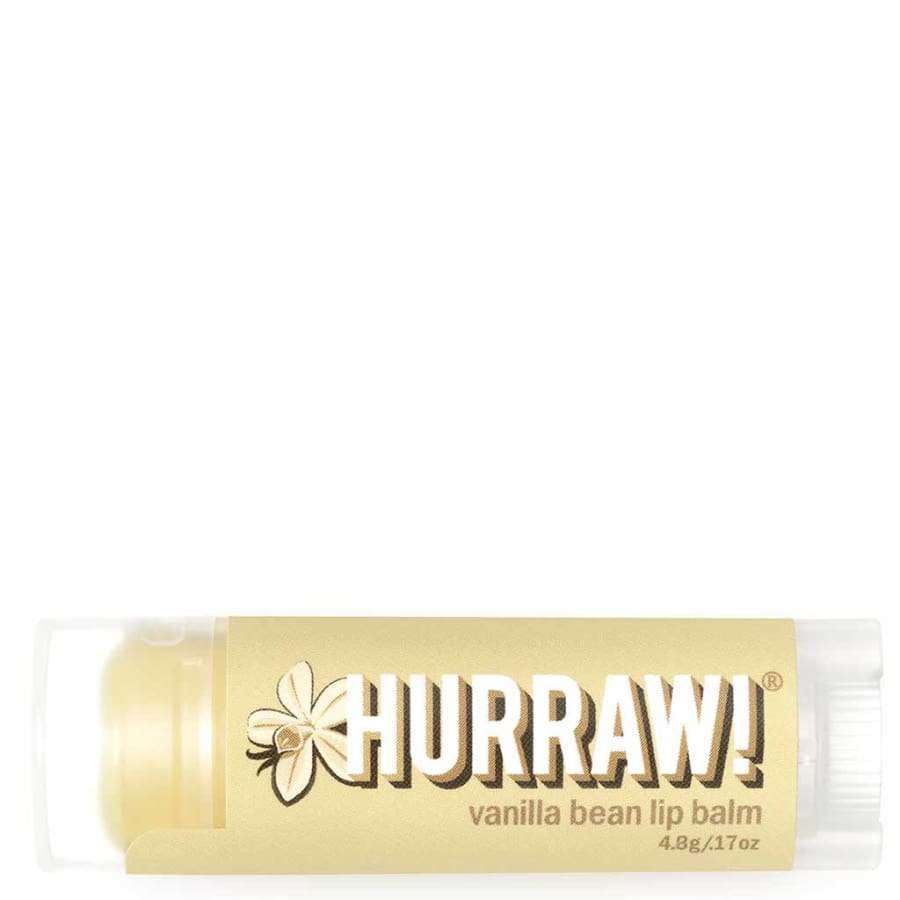 Hurraw! Huulivoide Vanilja -tuubi, beige etiketti, valkoinen teksti, vanilankukkakuvitus; kirkas korkki, mattapinta, lihavoitu groteskiteksti