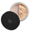 A round container of loose face powder with a black lid, partially open to reveal light beige mineral powder inside. The powder is separated into two sections by a divider. The container has a matte finish and the divider between powders is plastic. No visible typography or text on the product. Shot taken against a plain, neutral background with no people or hands present.