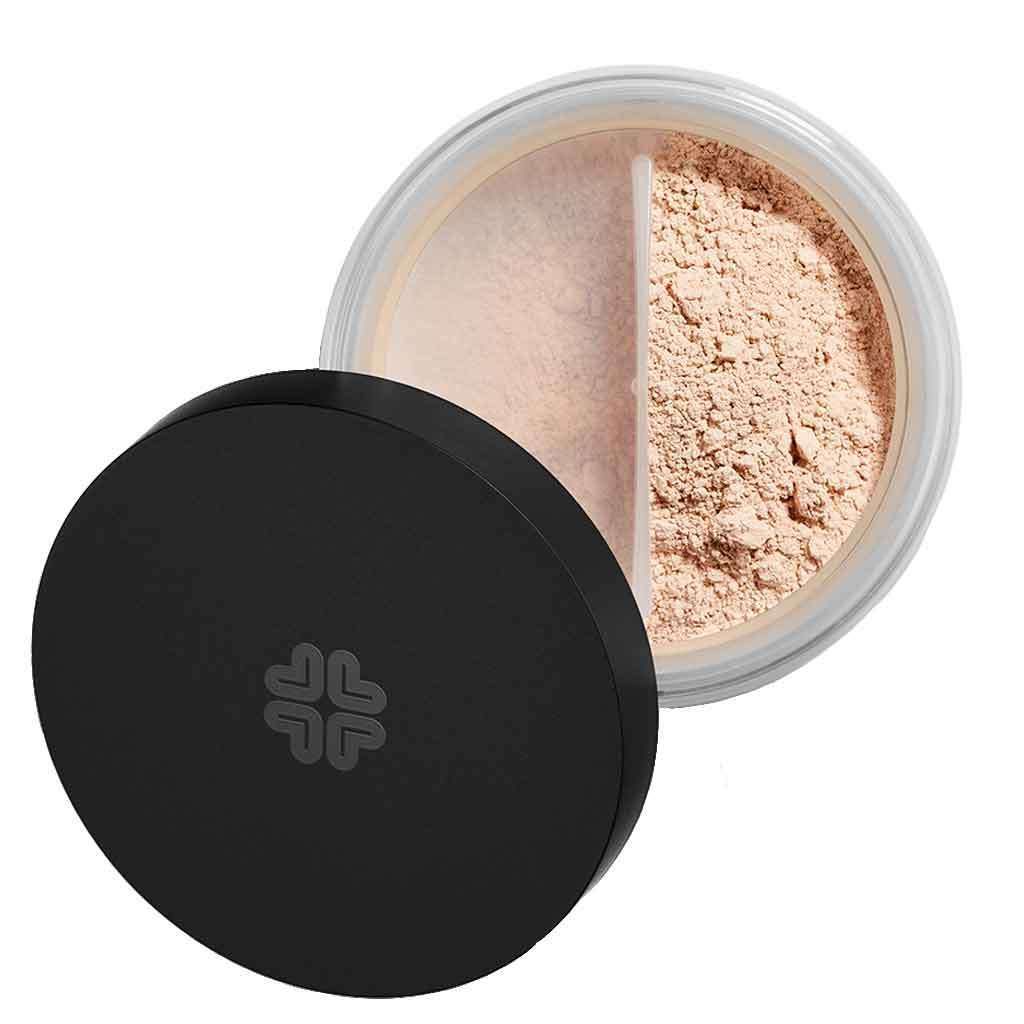 A round container of loose face powder with a black lid, partially open to reveal beige mineral powder inside. The jar features a divider separating the powder from the opening. The container has a matte black plastic lid and clear or frosted plastic base showing the powder. No visible typography or label text. Plain white studio background. No people or hands visible in the image.