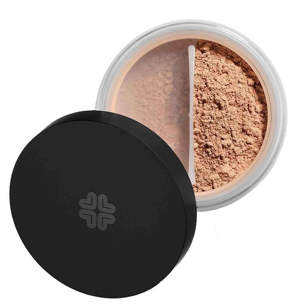 A round container of loose, light brown powder makeup with a black plastic lid, shown partially open to display the finely milled product inside. The lid has a matte finish and no visible label or text. The container appears clear or translucent. Photo is taken against a plain, white background with no people or hands visible.