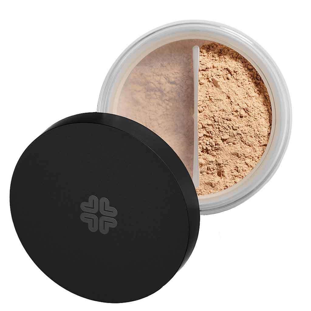 A round container of mineral loose powder foundation with a black matte-finish lid, partially open, revealing light tan powder inside divided by a white plastic inner separator. No visible branding or label text. The product sits against a plain, neutral background in a close-up shot. No people or hands are present.