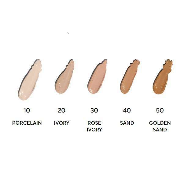 Five foundation swatches labeled: 10 Porcelain, 20 Ivory, 30 Rose Ivory, 40 Sand, and 50 Golden Sand are arranged from lightest to darkest shade left to right on a flat surface. Swatches have a creamy texture with a subtle sheen. Labels use clear sans-serif font printed below each swatch. Background is plain white with no visible people or hands. Medium-close shot.